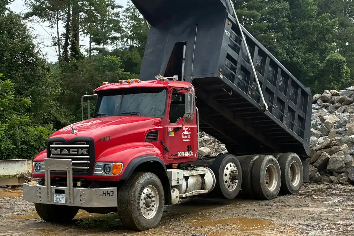 Dump truck hauling rock and project material