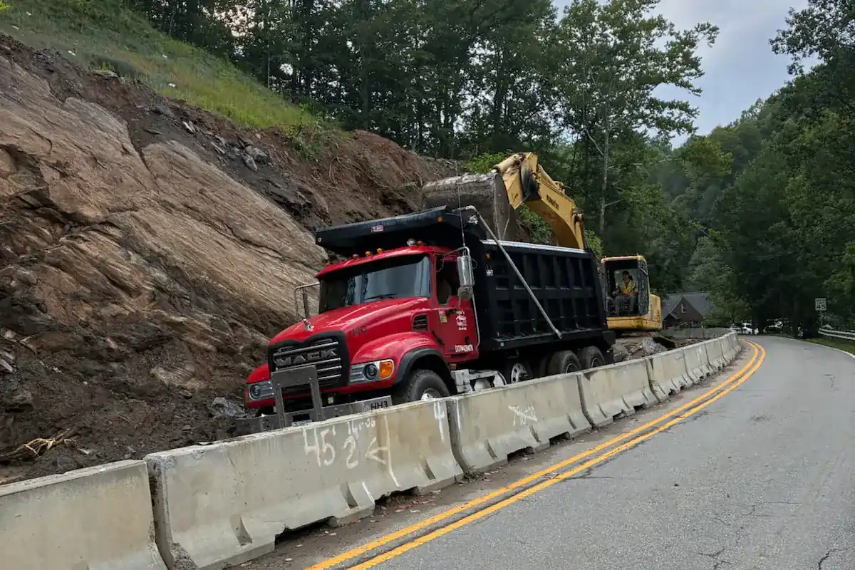 Grading and retaining work along a steep roadside